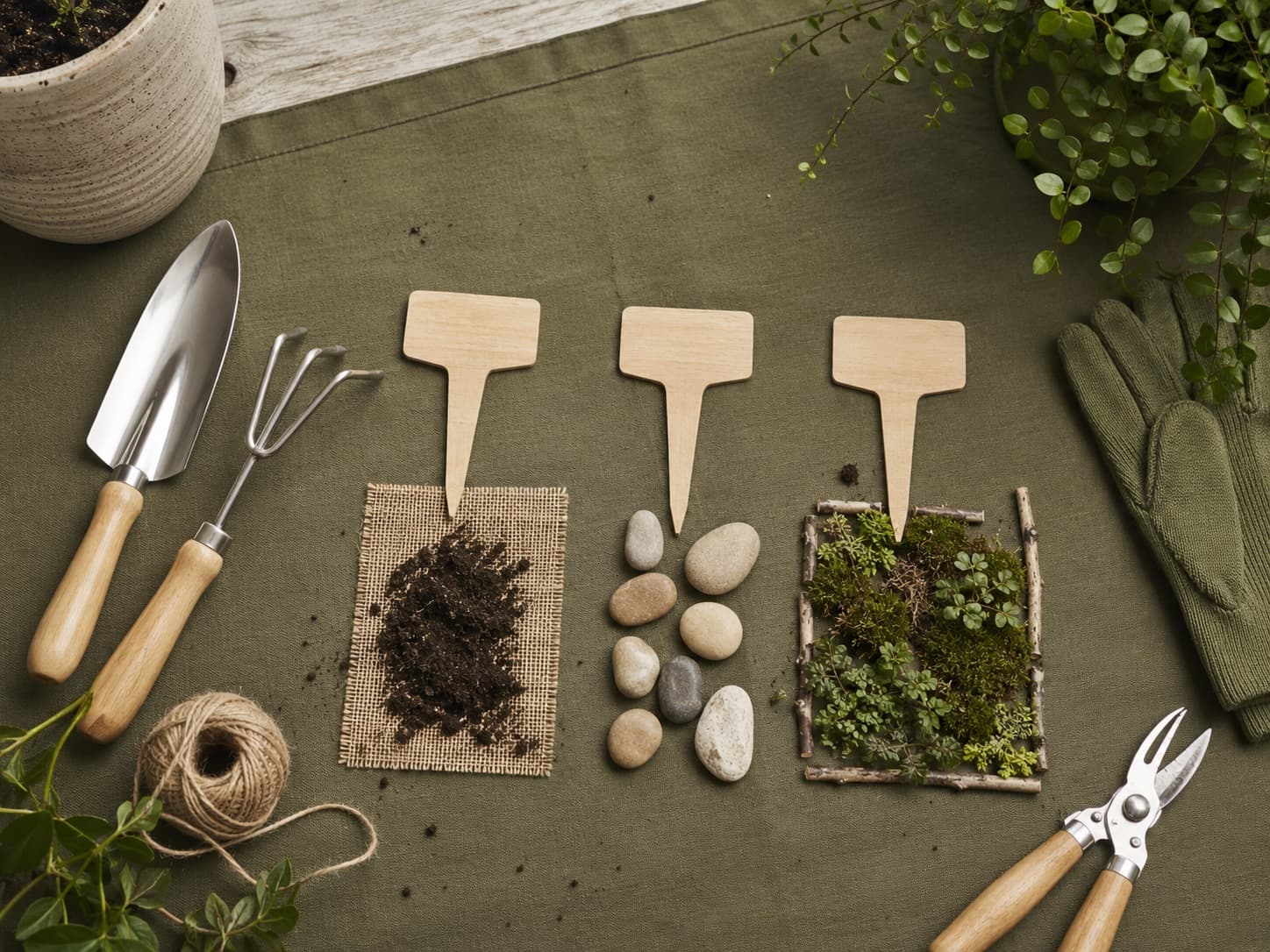 Three-stage tactile garden planning workbench with tools and markers